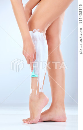 Studio, woman and shave legs with cream, body care and skincare or grooming on white background. Hair removal, cosmetic and hygiene with razor, pamper and routine for treatment for female person Studio, woman and shave legs with cream, body care and skincare or grooming on white background. Hair removal, cosmetic and hygiene with razor, pamper and routine for treatment for female person 115438546