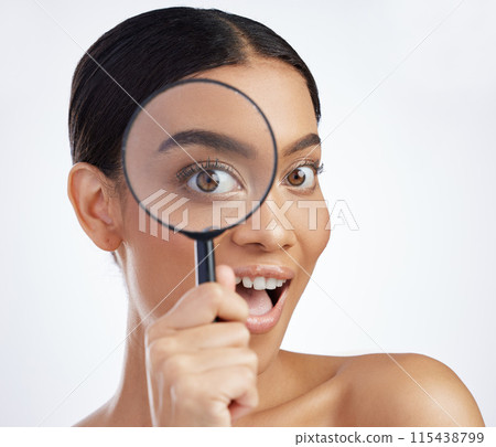 Skincare, portrait and woman with magnifying glass in studio for skin, inspection and cosmetics on white background. Face, beauty and girl model with search lens for fine lines, acne or dermatology 115438799