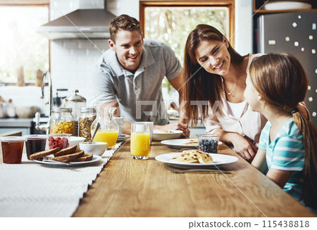 Family, breakfast and kid with smile in morning for healthy diet, growth and child development. Happy, father and mother with little girl with food on weekend for nutrition, support and care at home 115438818