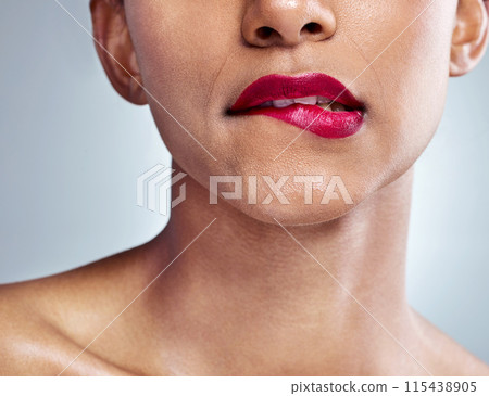 Woman, lips and lipstick for natural beauty and cosmetics, skin and closeup isolated on studio background. Model, sensual and makeup with skincare, shine and dermatology, bite and playful for fun Woman, lips and lipstick for natural beauty and cosmetics, skin and closeup isolated on studio background. Model, sensual and makeup with skincare, shine and dermatology, bite and playful for fun 115438905