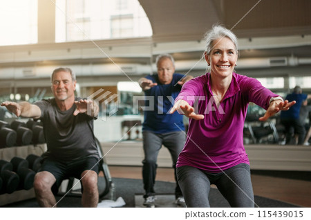 Mature group, woman and squat for exercise in gym, balance or coach for muscle development in class. Senior people, men and fitness for legs, smile or workout together in retirement at wellness club 115439015