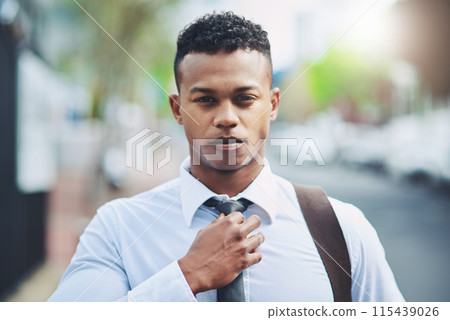 Businessman, portrait and confidence with tie in city for morning commute, travel to work and ready or serious. Professional, person or pride for corporate career, internship or employee on sidewalk 115439026