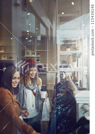 Shopping, decide and girl friends by clothes in retail mall for discount, sale or promotion. Style, window and young women bonding and buy designer outfit on rack at luxury fashion store or boutique. Shopping, decide and girl friends by clothes in retail mall for discount, sale or promotion. Style, window and young women bonding and buy designer outfit on rack at luxury fashion store or boutique. 115439148