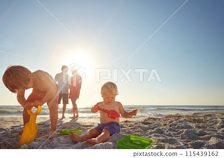 Sky, family and children with sand castle on beach for holiday, travel or vacation together. Mom, dad and kids playing outdoor on tropical island coast with toys for bonding, building or development Sky, family and children with sand castle on beach for holiday, travel or vacation together. Mom, dad and kids playing outdoor on tropical island coast with toys for bonding, building or development 115439162