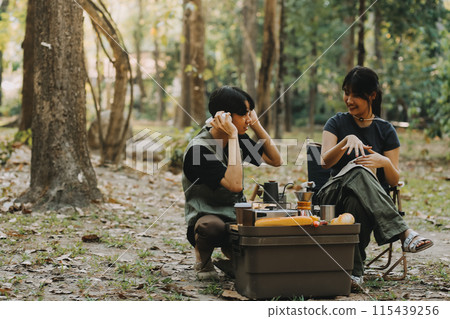 Asian couple sweet in tent inside on they camping trip, traveller relax and sleep togather in out door and camping trip Asian couple sweet in tent inside on they camping trip, traveller relax and sleep togather in out door and camping trip 115439256