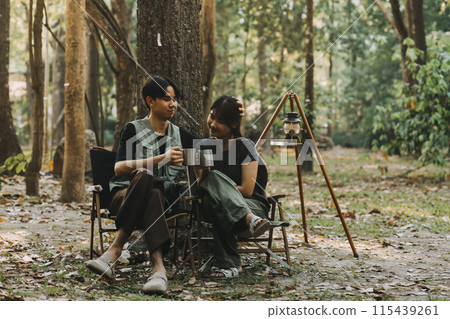 Asian couple sweet in tent inside on they camping trip, traveller relax and sleep togather in out door and camping trip Asian couple sweet in tent inside on they camping trip, traveller relax and sleep togather in out door and camping trip 115439261