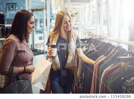 Fashion, shopping and friends with decision for clothes, sales and discount at luxury mall. Smile, retail store and customer with fabric at boutique for choice with women and girls drinking coffee 115439286