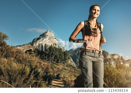 Portrait, hiking and woman with nature, sunshine and outdoor for adventure, mountain and travel. Person, hiker and healthy girl with environment, fitness and wellness with vacation, energy and smile 115439314
