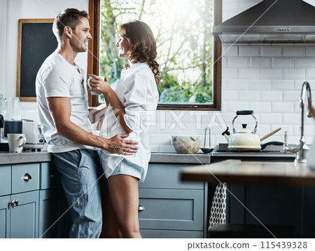 Tea, hug and happy couple in kitchen for love, romance or bonding together with an intimate connection. Man, woman and people embrace in celebration of marriage anniversary in the morning at home Tea, hug and happy couple in kitchen for love, romance or bonding together with an intimate connection. Man, woman and people embrace in celebration of marriage anniversary in the morning at home 115439328