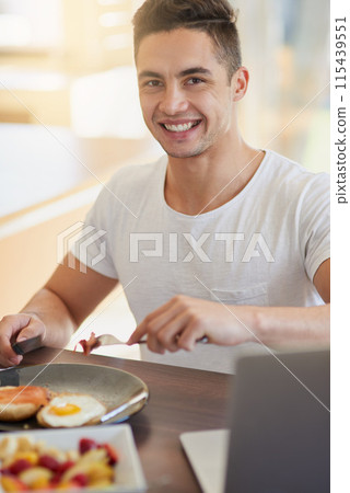 Man, portrait and eating breakfast in house with cutting bacon, healthy meal and nutrition in dining room. Person, wellness and happy nutritionist with organic brunch for detox, vegan diet and relax 115439551