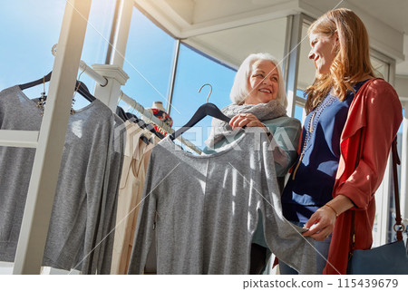 Mature woman, shopping and retail clothes, choice, decision and brand fashion sale for luxury wardrobe at boutique. Smile, people and customer, designer product or quality fabric at supplier store 115439679