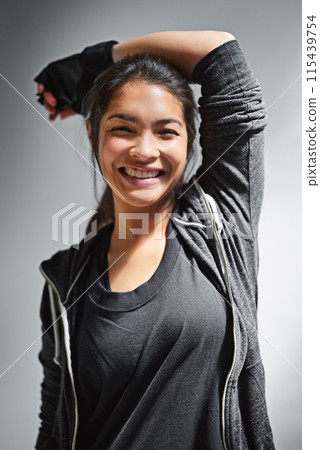 Portrait, woman and confidence for fitness and happiness, smile and gym on gray background. Workout, face and exercise for athlete person, gloves and health training in studio for personal trainer 115439754