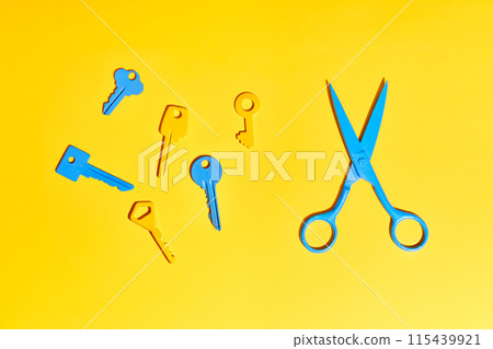 Blue scissors and colorful keys on yellow Blue scissors and colorful keys on yellow 115439921