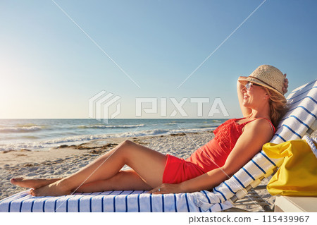 Woman, smile and relax on chair at beach for tropical island, vacation and outdoor holiday in summer. Female person, hat and happy with sunglasses by ocean for sunshine, travel and tourism in Bali 115439967