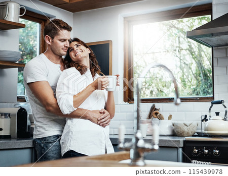 Coffee, smile or happy couple in kitchen for love, romance or bonding together with an intimate connection. Man, woman and people embrace in celebration of marriage support in the morning at home 115439978
