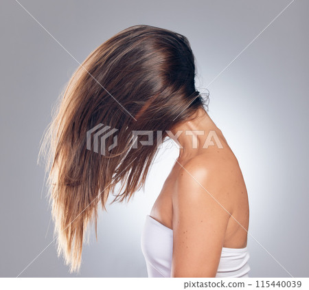 Woman, hair care and movement in studio with growth, keratin treatment and balayage on white background. Salon, excited and female person with cosmetic shine for style, texture and wellness or beauty 115440039