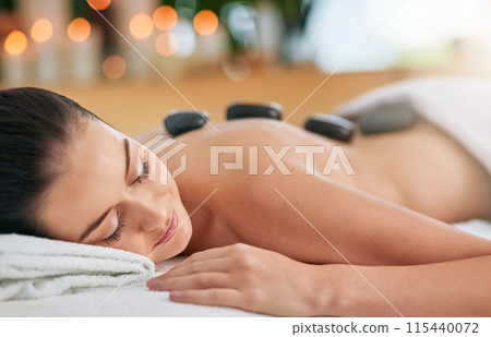 Back, hot stone for massage and woman in spa, on bed to relax for health, peace or wellness. Beauty, calm or wellbeing with client and skincare in clinic or salon for stress relief treatment Back, hot stone for massage and woman in spa, on bed to relax for health, peace or wellness. Beauty, calm or wellbeing with client and skincare in clinic or salon for stress relief treatment 115440072