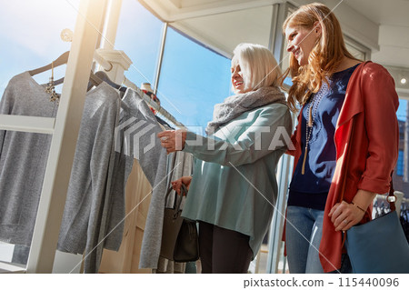 Family, mature woman and shopping for clothing choice, decision and retail fashion sale for luxury wardrobe at boutique. Smile, mother and customer advice, designer product for quality fabric at shop 115440096