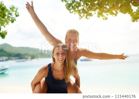 Travel, beach and portrait of women with piggyback in sunshine for holiday, spring break or adventure. Smile, students and college friends for happiness, freedom or seaside getaway trip to Bahamas 115440176