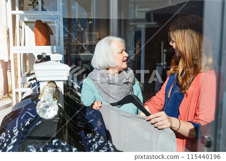 Woman, mature mother and shopping for retail clothes decision, brand fashion and luxury wardrobe at boutique. Smile, people and family bonding, designer product and quality fabric at supplier store Woman, mature mother and shopping for retail clothes decision, brand fashion and luxury wardrobe at boutique. Smile, people and family bonding, designer product and quality fabric at supplier store 115440196