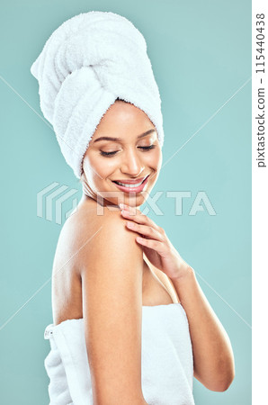 Towel, thinking and model girl in studio for shower, hygiene and smile for cleaning. Woman, happy and idea for wellness or grooming in morning with routine, glow and skincare by blue background 115440438