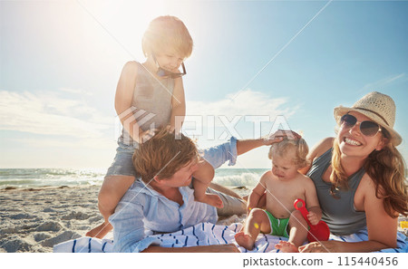 Portrait, relax or kids with parents at beach on holiday vacation or happy family weekend together. Father, fun mother or children siblings at sea for bonding or playing in nature in Spain with love 115440456