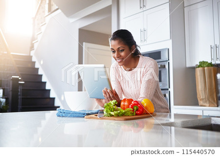 Tablet, ingredients and woman in kitchen for cooking with health, wellness and diet recipe. Smile, vegetables and Indian female person with digital technology for nutrition meal instructions at home. Tablet, ingredients and woman in kitchen for cooking with health, wellness and diet recipe. Smile, vegetables and Indian female person with digital technology for nutrition meal instructions at home. 115440570