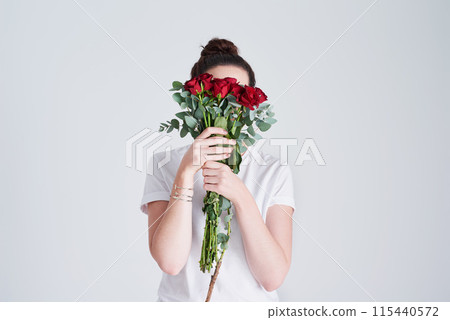 Bouquet, woman hide face and rose for love with anniversary present, natural and sustainable product in studio. Female person, romantic flowers and leaves for floral gift and date by white background Bouquet, woman hide face and rose for love with anniversary present, natural and sustainable product in studio. Female person, romantic flowers and leaves for floral gift and date by white background 115440572