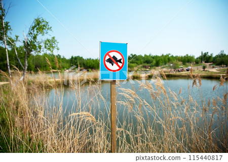 Prohibitory sign fishing is prohibited against lakes and forest in the park. Prohibitory sign fishing is prohibited against lakes and forest in the park. 115440817