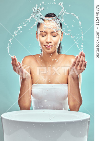 Sink, woman and water splash in studio for hygiene, cleaning and cosmetics for skincare. Model girl, washing face and wellness for morning, facial and dermatology for glow by blue background 115440878