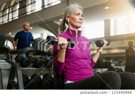 Dumbbell, music and training with mature woman on bench in gym for physical fitness or workout. Exercise, health and weight with confident athlete person in performance club for active challenge Dumbbell, music and training with mature woman on bench in gym for physical fitness or workout. Exercise, health and weight with confident athlete person in performance club for active challenge 115440994
