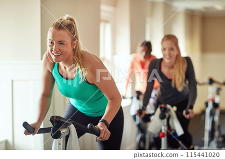 Woman, exercise bike and coach at gym, training and cycling for fitness or spin class. Female person, riding and stationary machine for workout challenge, aerobic instructor and equipment for cardio Woman, exercise bike and coach at gym, training and cycling for fitness or spin class. Female person, riding and stationary machine for workout challenge, aerobic instructor and equipment for cardio 115441020