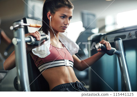 Workout, girl and chest press in gym for fitness, power and muscle development with earphones or towel. Music, training and exercise in sports club for wellness, health and results with commitment Workout, girl and chest press in gym for fitness, power and muscle development with earphones or towel. Music, training and exercise in sports club for wellness, health and results with commitment 115441125