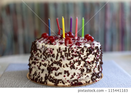 Black Forest cake with cherries, chocolate chips and whipped cream. Birthday cake with candles. Shvartsvald cherry cake, a traditional German pastry. Selective focus, close-up. Black Forest cake with cherries, chocolate chips and whipped cream. Birthday cake with candles. Shvartsvald cherry cake, a traditional German pastry. Selective focus, close-up. 115441183