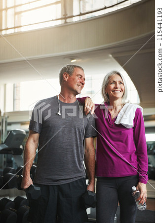 Senior couple, training and break at gym, bottle and dumbbell with happy memory, exercise and health. Man, woman and smile together for support, workout and motivation with water at wellness club Senior couple, training and break at gym, bottle and dumbbell with happy memory, exercise and health. Man, woman and smile together for support, workout and motivation with water at wellness club 115441193
