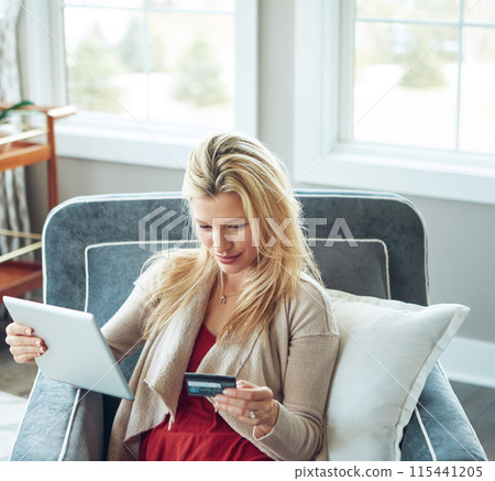 Woman, credit card and tablet in living room, fintech and online transaction for shopping in house. Customer, internet payment and sale or banking app, ecommerce and relax for happy purchase on chair 115441205