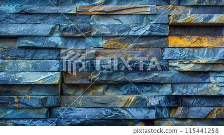 a textured stone wall with shades of blue and yellow with rough and uneven surface 115441258