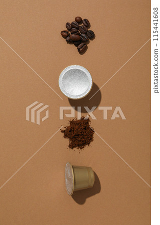 Coffee capsules and beans on brown background, space for text 115441608
