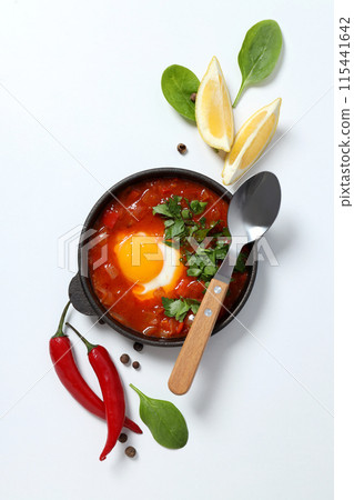 Shakshuka with fresh lemon on a white background Shakshuka with fresh lemon on a white background 115441642