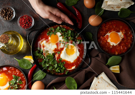 Shakshuka with fresh vegetables on a dark background Shakshuka with fresh vegetables on a dark background 115441644