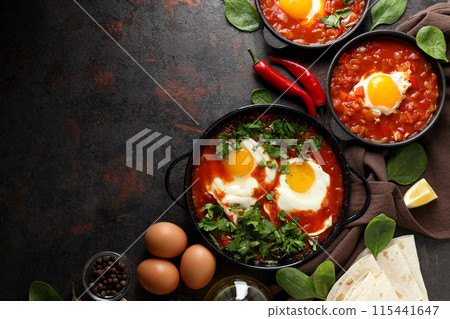 Shakshuka with fresh vegetables on a dark background Shakshuka with fresh vegetables on a dark background 115441647