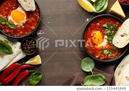 Shakshuka with fresh vegetables on a dark background Shakshuka with fresh vegetables on a dark background 115441649