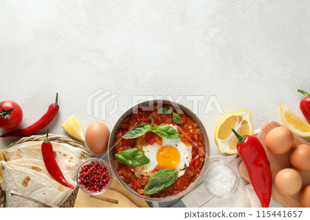 Shakshuka in a bowl on a light background Shakshuka in a bowl on a light background 115441657