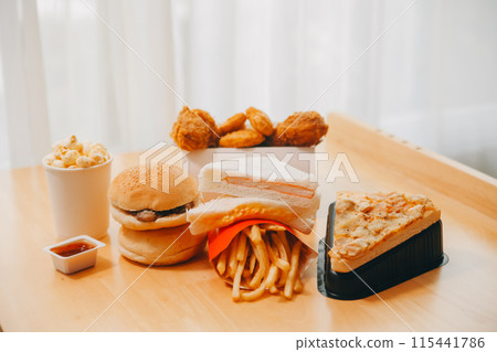 Closeup of home made burgers on wooden background Closeup of home made burgers on wooden background 115441786