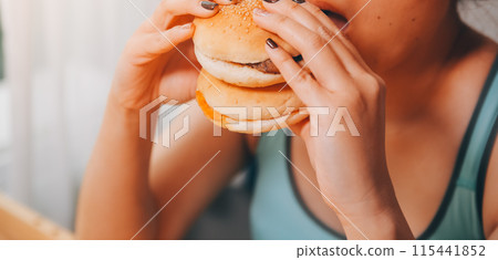 Binge eating disorder concept with woman eating fast food burger, fired chicken , donuts and desserts Binge eating disorder concept with woman eating fast food burger, fired chicken , donuts and desserts 115441852