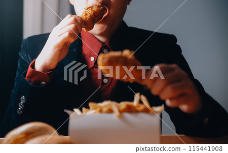 close up focus woman hand hold fried chicken for eat,girl with fast food concept 115441908