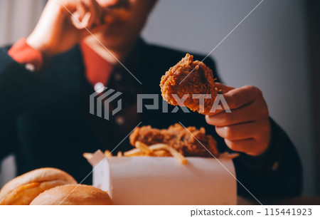 close up focus woman hand hold fried chicken for eat,girl with fast food concept close up focus woman hand hold fried chicken for eat,girl with fast food concept 115441923
