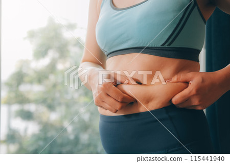 fat woman, fat belly, chubby, obese woman hand holding excessive belly fat with measure tape, woman diet lifestyle concept fat woman, fat belly, chubby, obese woman hand holding excessive belly fat with measure tape, woman diet lifestyle concept 115441940