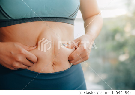 fat woman, fat belly, chubby, obese woman hand holding excessive belly fat with measure tape, woman diet lifestyle concept fat woman, fat belly, chubby, obese woman hand holding excessive belly fat with measure tape, woman diet lifestyle concept 115441943