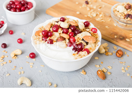 Healthy breakfast food with granola, yogurt, fruits and nuts. Dessert parfait with dried fruits for breakfast 115442006